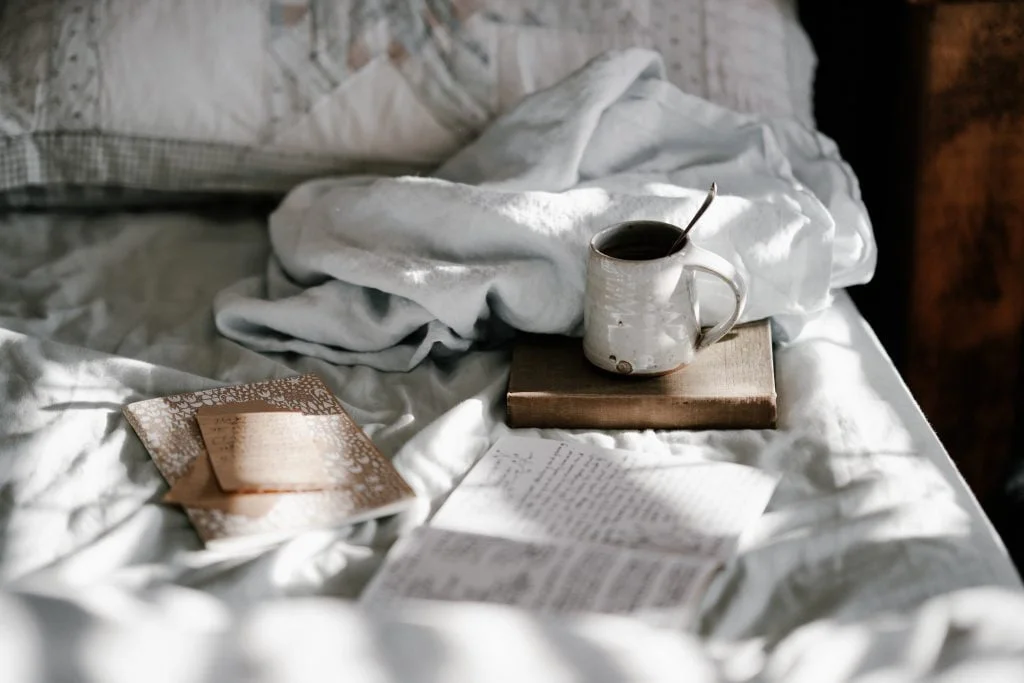 Coffee mug on bed