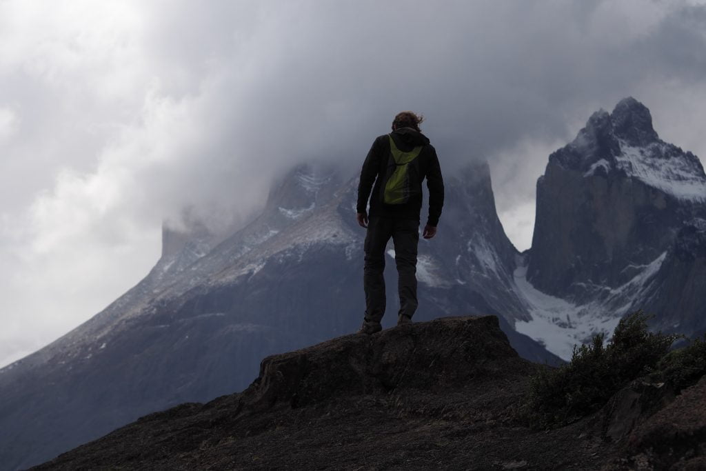 Man on mountain top in fog